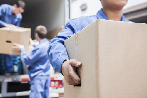 Removal staff preparing furniture safely during a house move