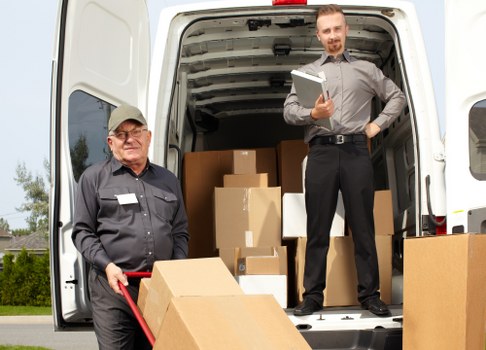 Moving team handling removal boxes during a scheduled house move