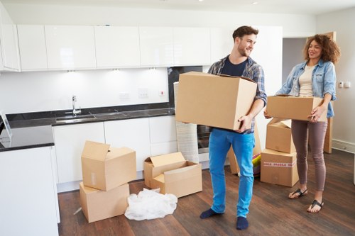 Removal crew separating furniture and packaging into recycling streams
