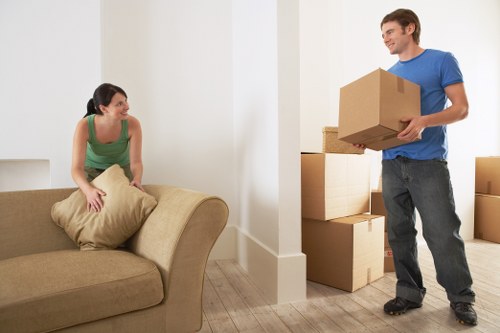 Removal van and heavy household items being loaded for a Greenwich move